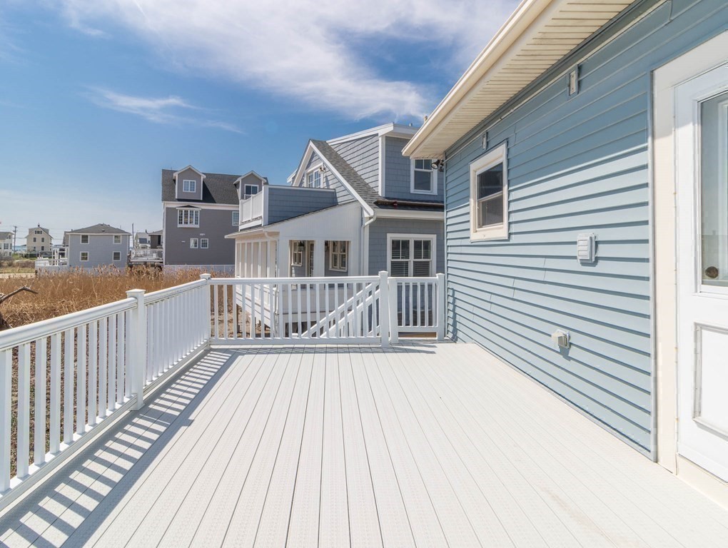 36 Ocean Avenue, Unit OCEAN VIEW Hull, MA 02045 - Photo 16 of 38 a view of a house with wooden deck