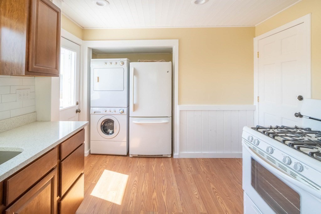 36 Ocean Avenue, Unit OCEAN VIEW Hull, MA 02045 - Photo 17 of 38 a kitchen with a refrigerator and a stove top oven