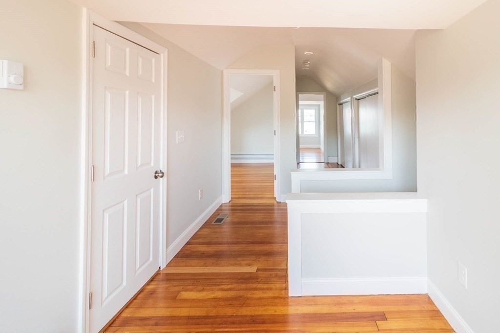 36 Ocean Avenue, Unit OCEAN VIEW Hull, MA 02045 - Photo 25 of 38 a view of a hallway with wooden floor and staircase