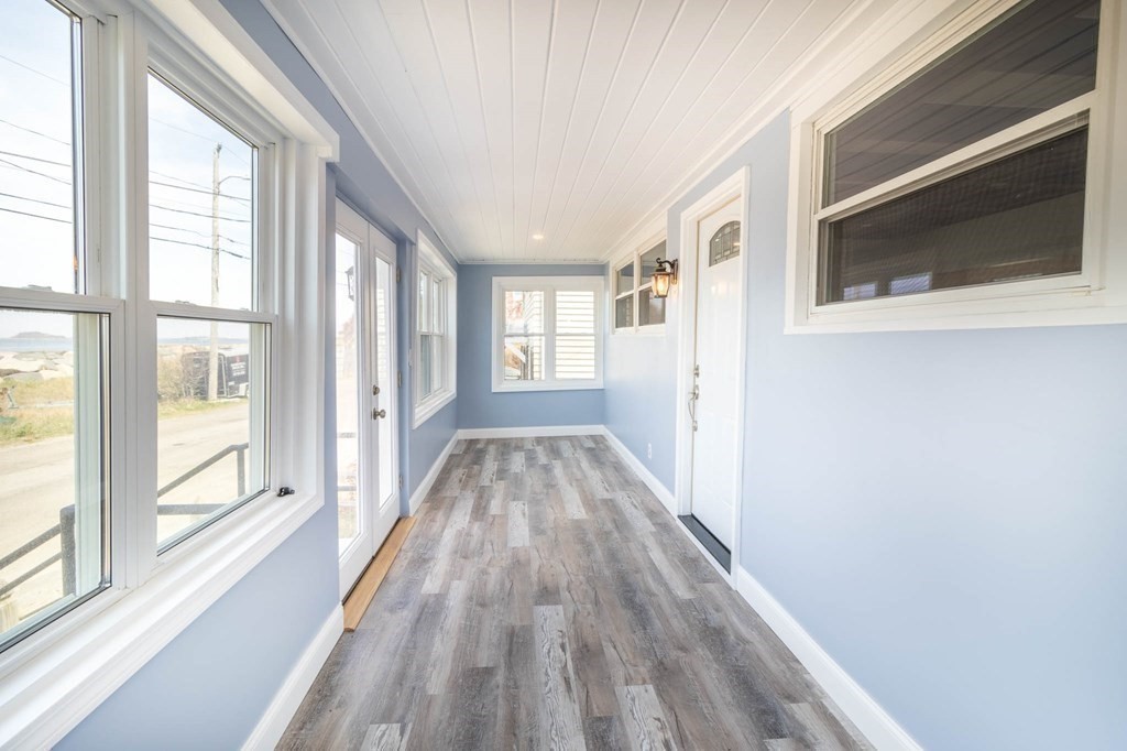 36 Ocean Avenue, Unit OCEAN VIEW Hull, MA 02045 - Photo 6 of 38 a view of a hallway with wooden floor and staircase