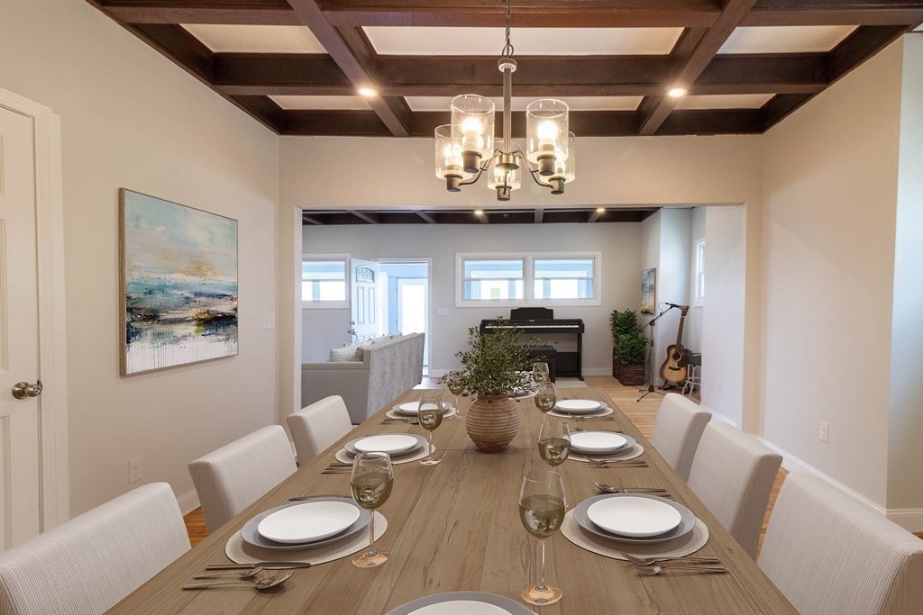 36 Ocean Avenue, Unit OCEAN VIEW Hull, MA 02045 - Photo 10 of 38 a view of a dining room with furniture a chandelier and wooden floor