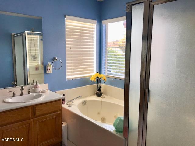 757 Navigator Way Oxnard, CA 93035 - Photo 14 of 23 a bathroom with a tub sink and mirror