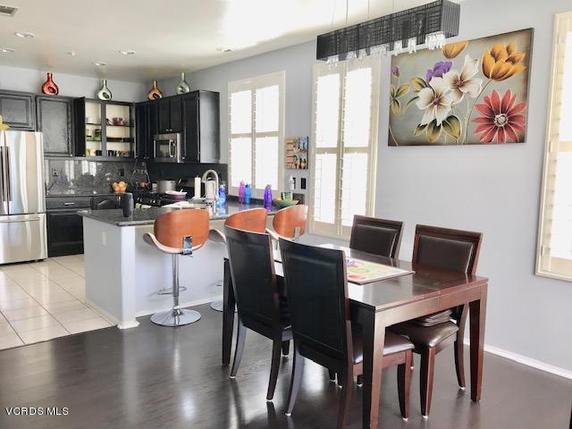 757 Navigator Way Oxnard, CA 93035 - Photo 9 of 23 a view of a dining room with furniture a kitchen and chandelier