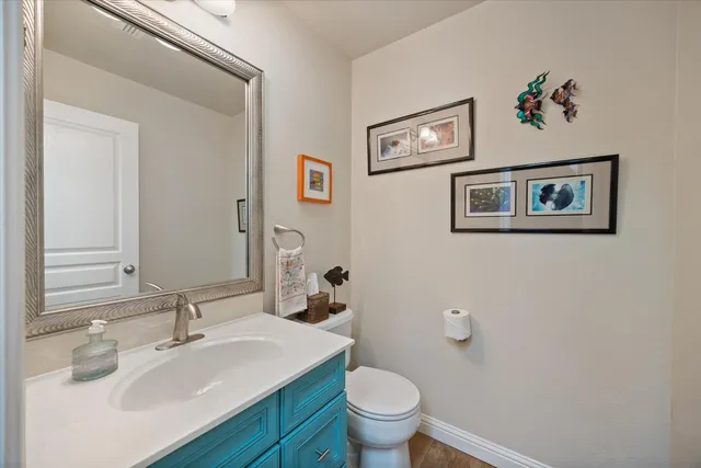 a bathroom with a sink mirror and toilet