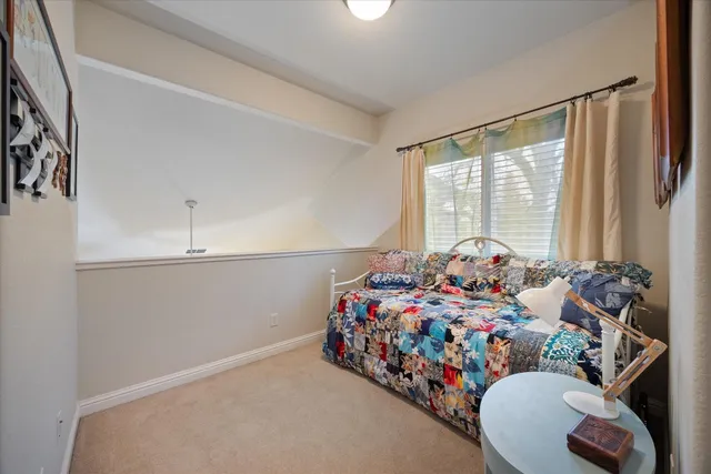 a bedroom with bed and a window