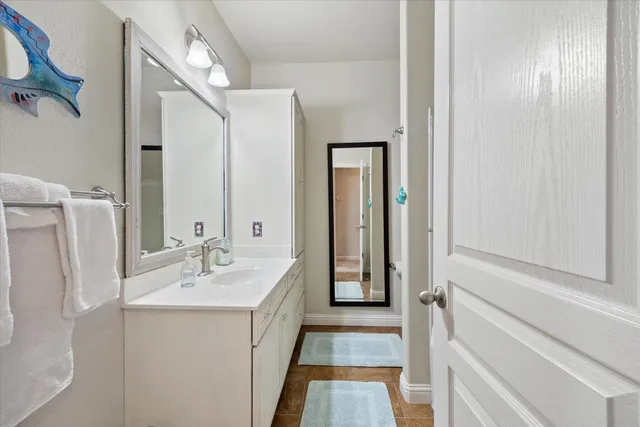 a bathroom with a glass shower door