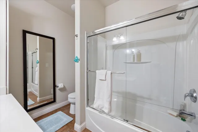 a white toilet sitting next to a bathroom sink