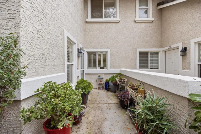 front view of a house with a potted plant