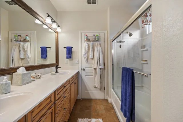 a view of a white house with a large windows and palm trees
