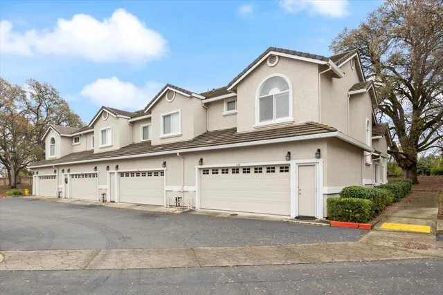 a view of a house with a outdoor space and parking area