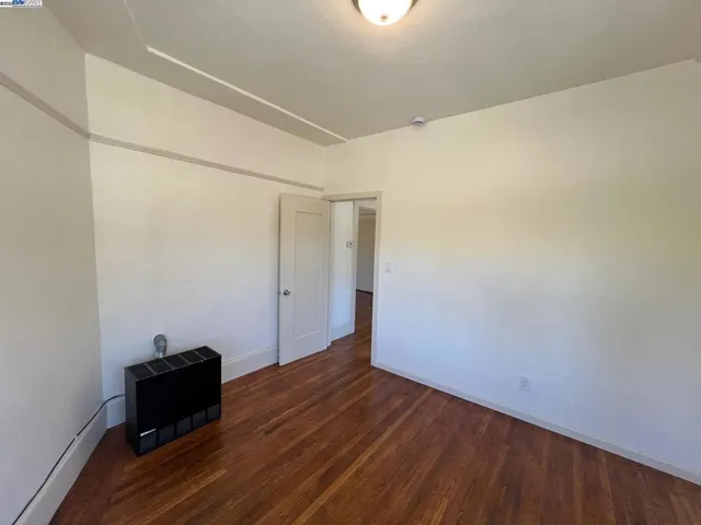 a room with wooden floor and a window