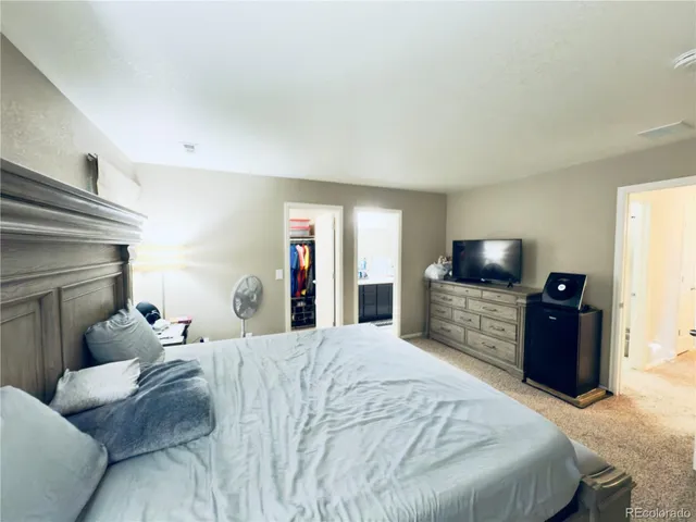 a bedroom with a bed and a television