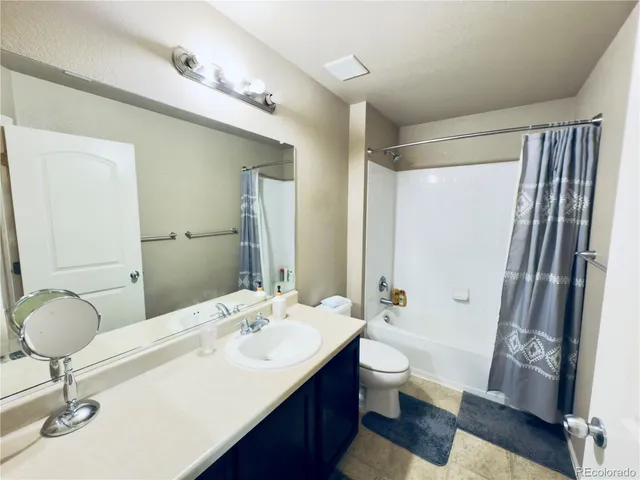 a bathroom with a double vanity sink toilet and shower