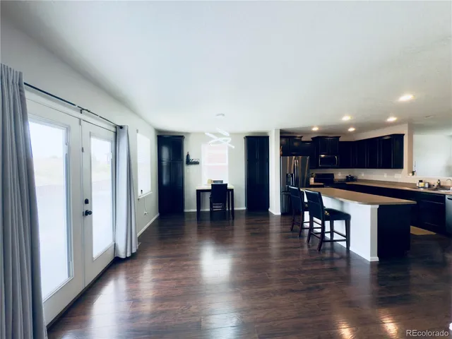 a view of kitchen with cabinets and wooden floor