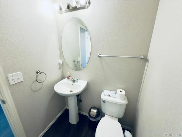 a bathroom with a sink mirror and toilet