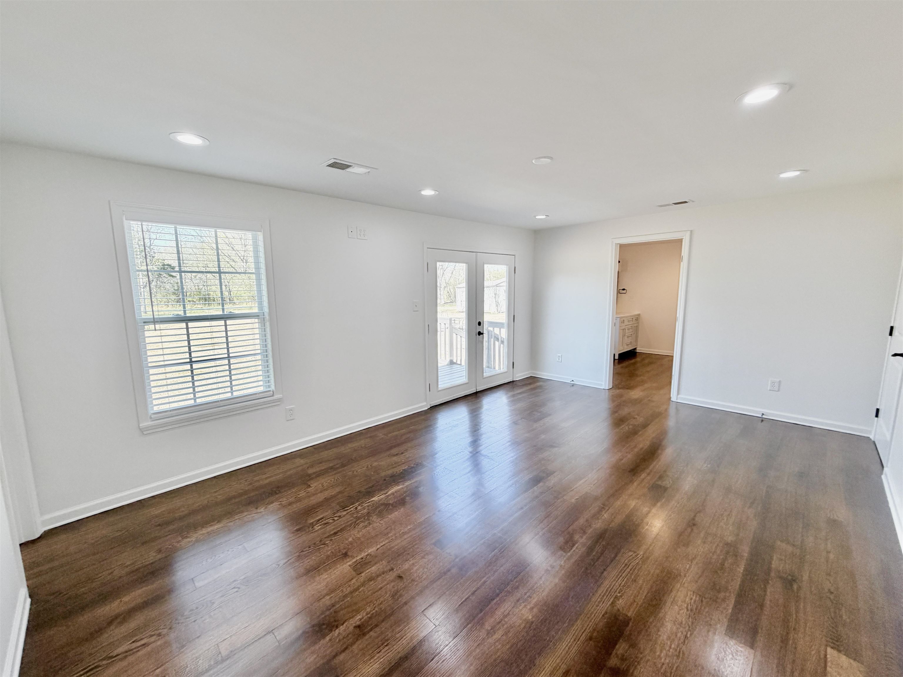 9526 Osborn Road Arlington, TN 38002 - Photo 13 of 40 Unfurnished room with french doors, healthy amount of natural light, dark hardwood flooring, and recessed lighting