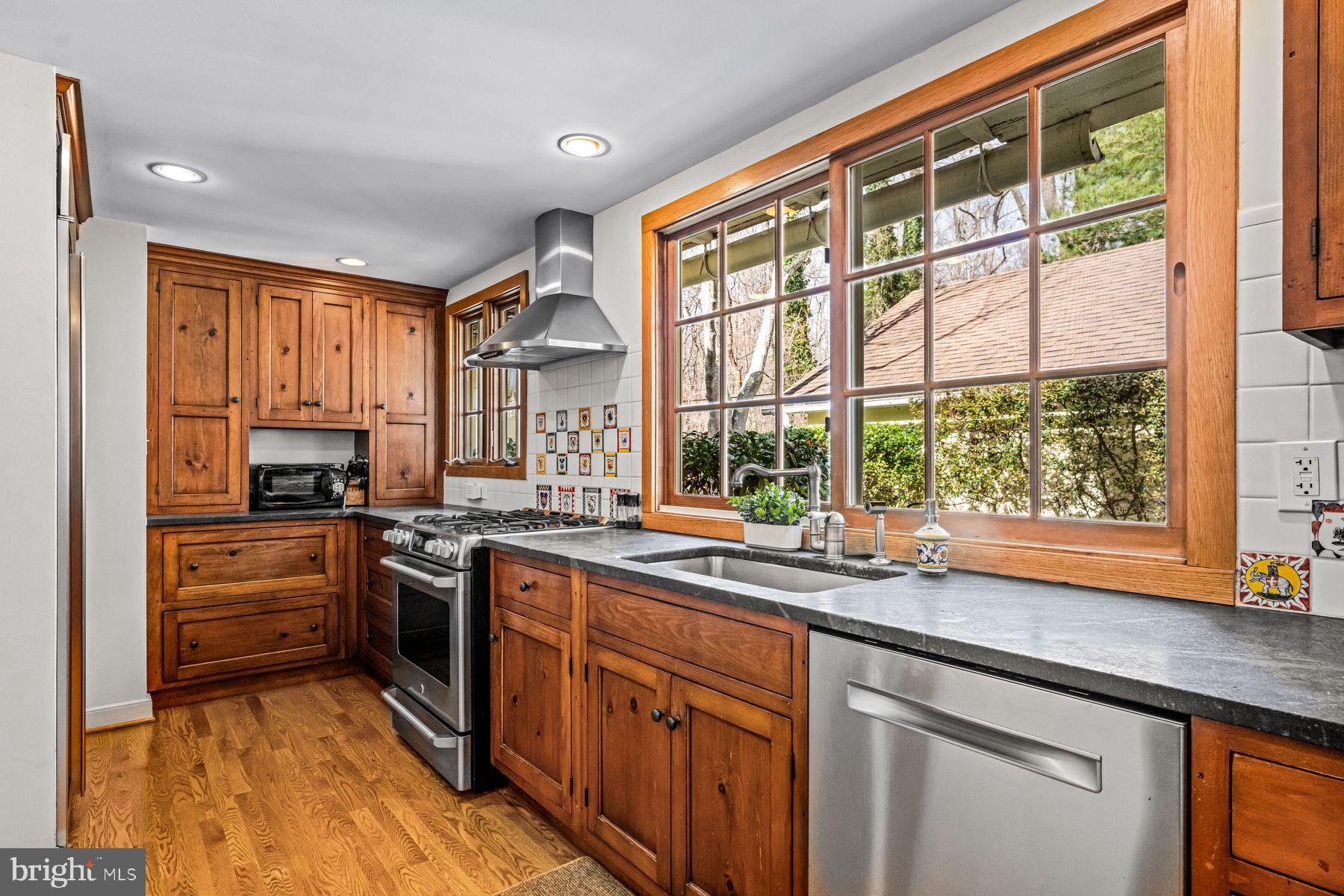 385 Church Road Devon, PA 19333 - Photo 18 of 59 a kitchen with stainless steel appliances granite countertop sink stove and refrigerator