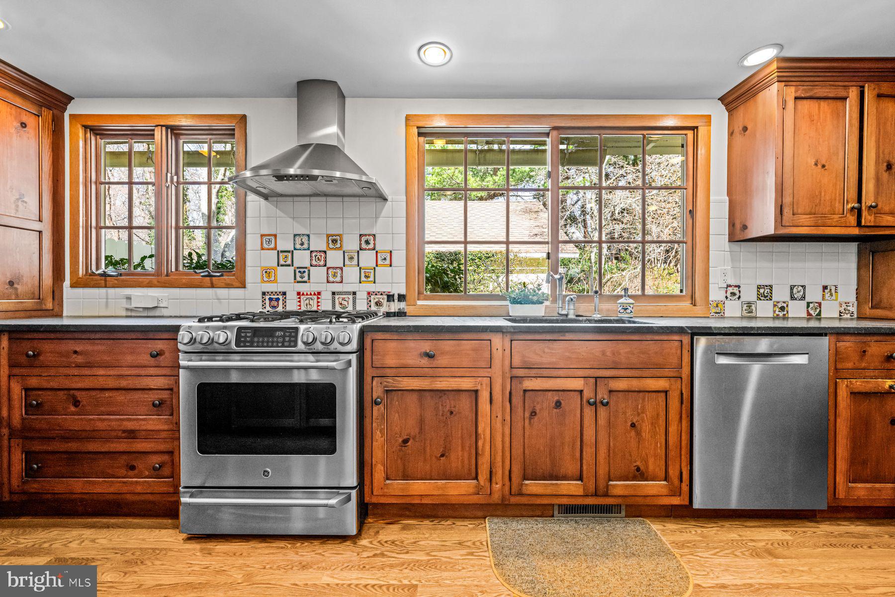 385 Church Road Devon, PA 19333 - Photo 19 of 59 a kitchen with stainless steel appliances granite countertop a stove and a microwave