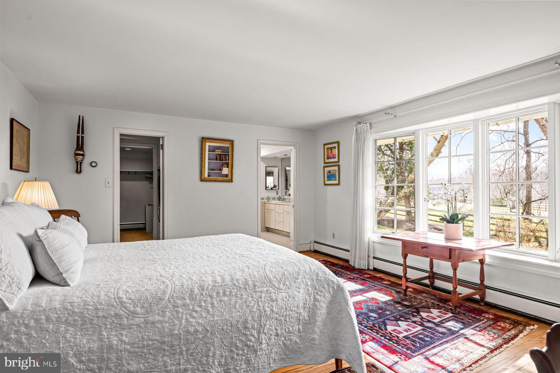 385 Church Road Devon, PA 19333 - Photo 27 of 59 a bedroom with a bed wooden floor and a large window