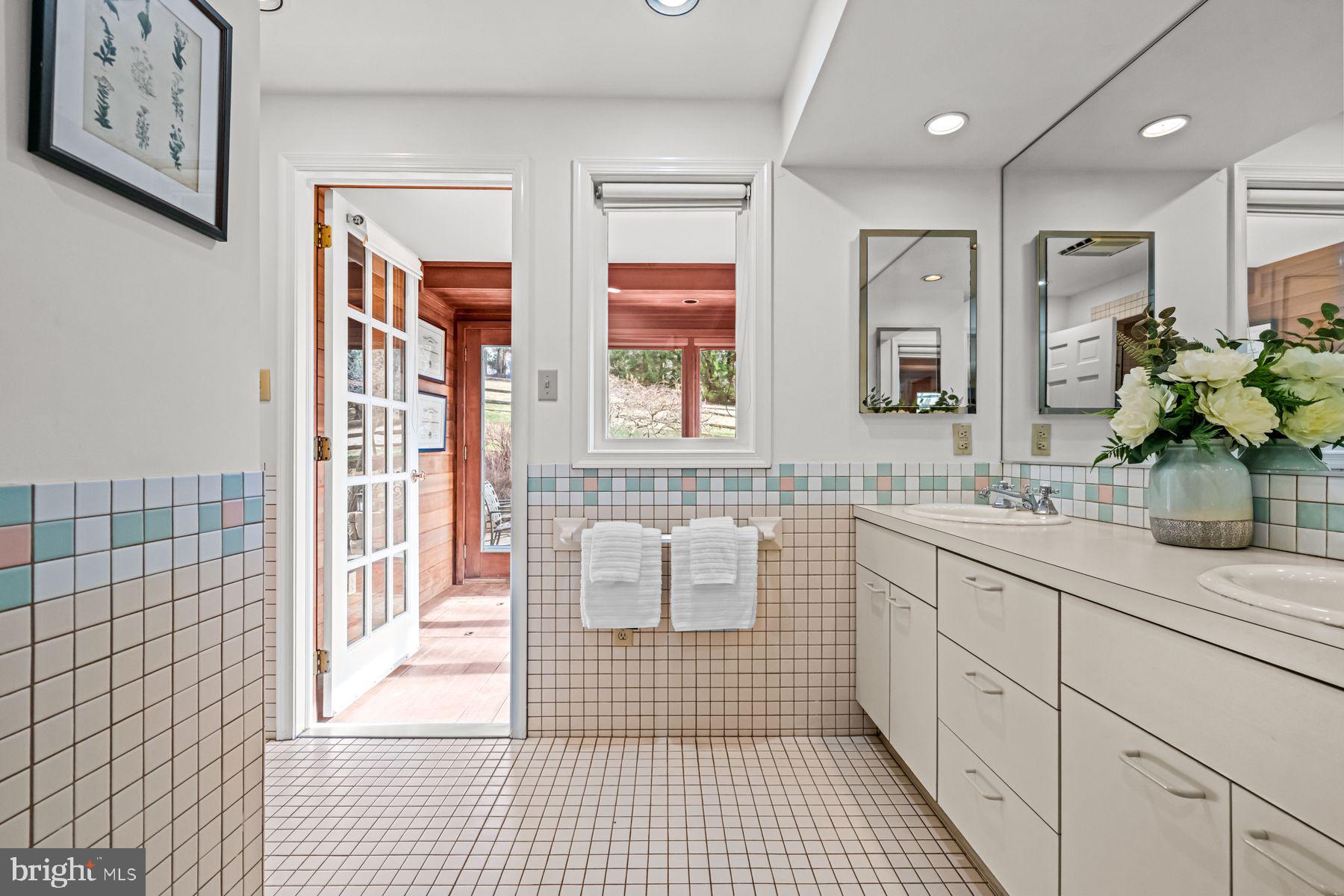 385 Church Road Devon, PA 19333 - Photo 32 of 59 a spacious bathroom with a double vanity sink a large mirror and shower