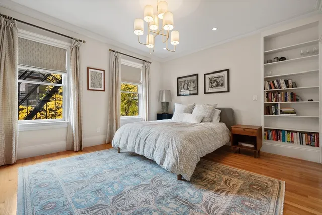 a spacious bedroom with a bed and a window