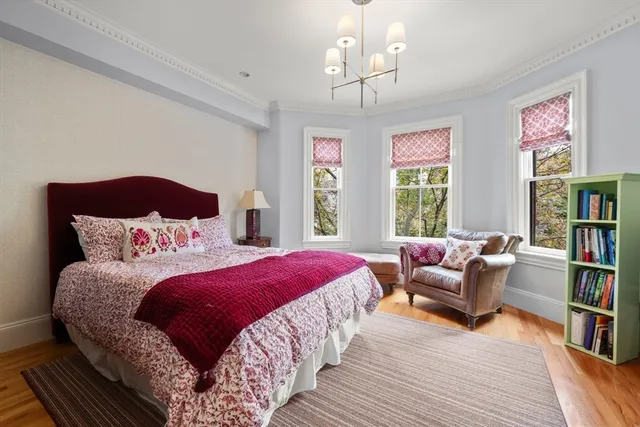 a bedroom with bed and a book shelf