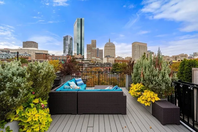 a view of a balcony with wooden benches