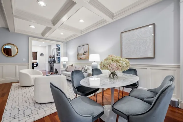 a living room with furniture kitchen view and a large mirror