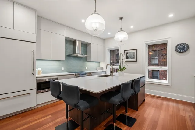 a kitchen with a table chairs stove and microwave