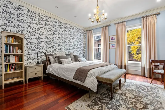 a bedroom with a bed and a book shelf