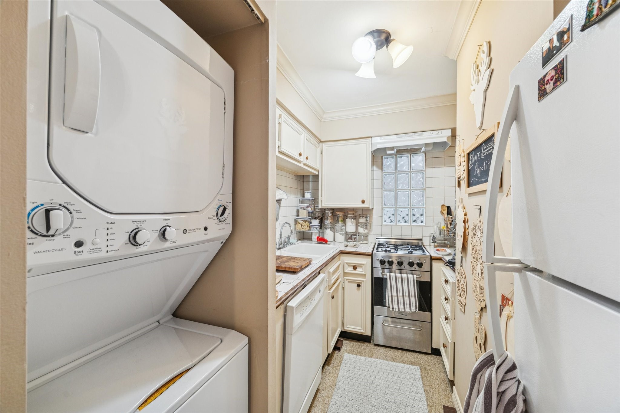 4207 Drake Street Houston, TX 77005 - Photo 17 of 24 a view of a kitchen with a sink and dishwasher a refrigerator with wooden floor