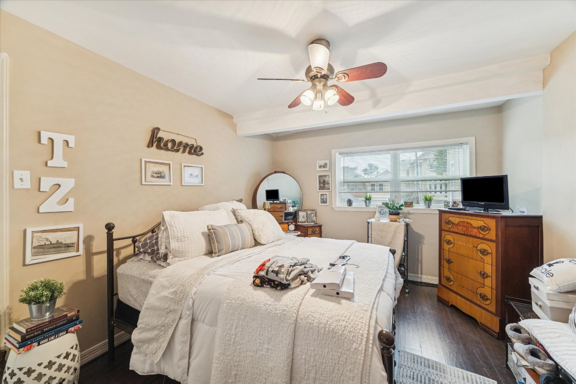 4207 Drake Street Houston, TX 77005 - Photo 18 of 24 This spacious bedroom offers a comfortable retreat with updated flooring, a ceiling fan, neutral paint, and soft natural light. The versatile layout easily accommodates a full bedroom setup while appealing to tenants seeking both comfort and functionality.