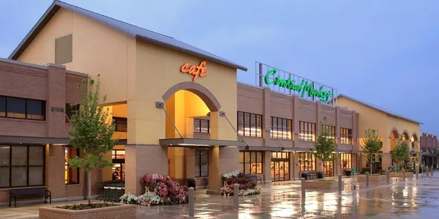 a view of an empty room with wooden floor and windows