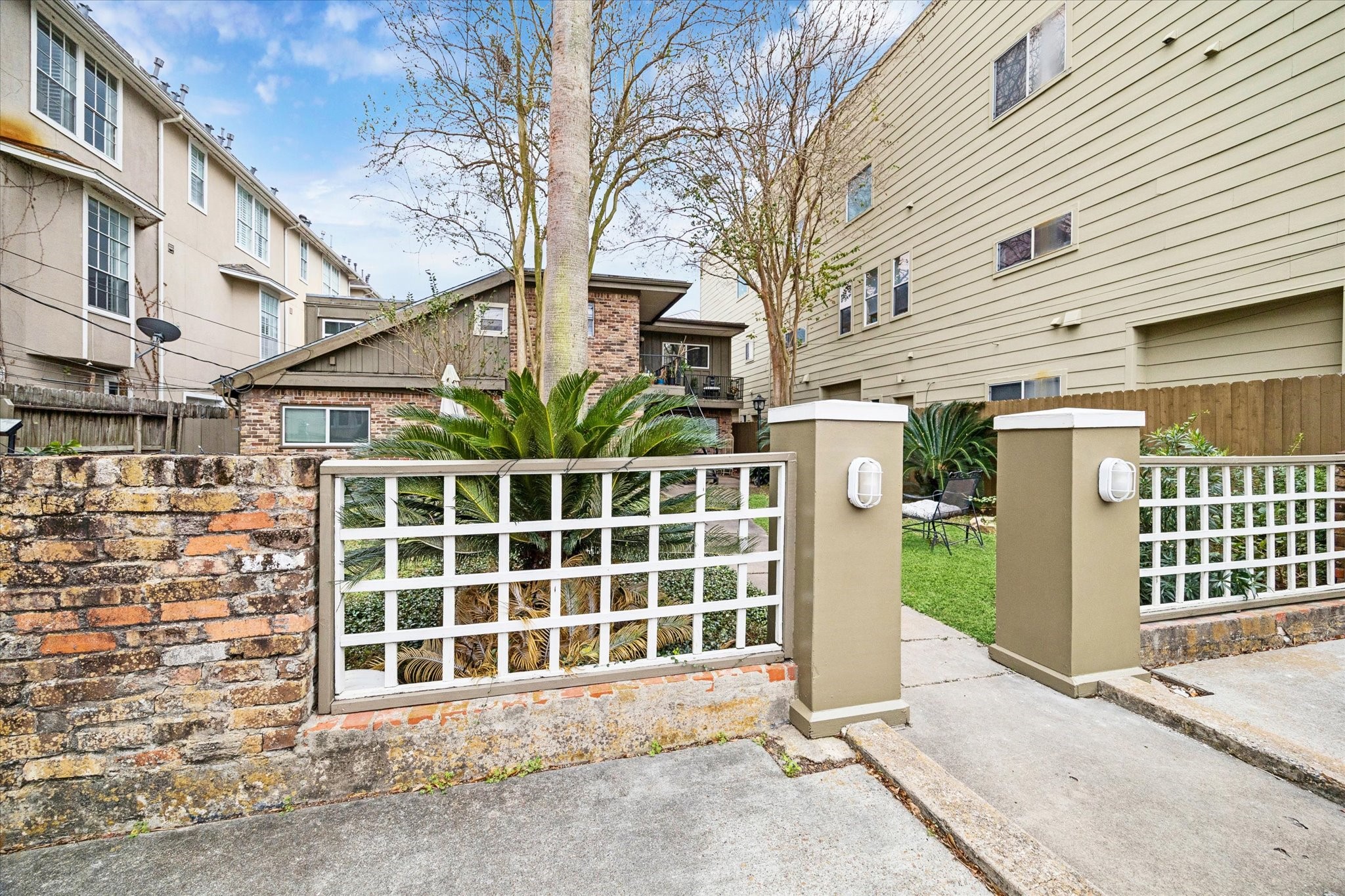 4207 Drake Street Houston, TX 77005 - Photo 3 of 24 a view of a house with a large window and wooden fence