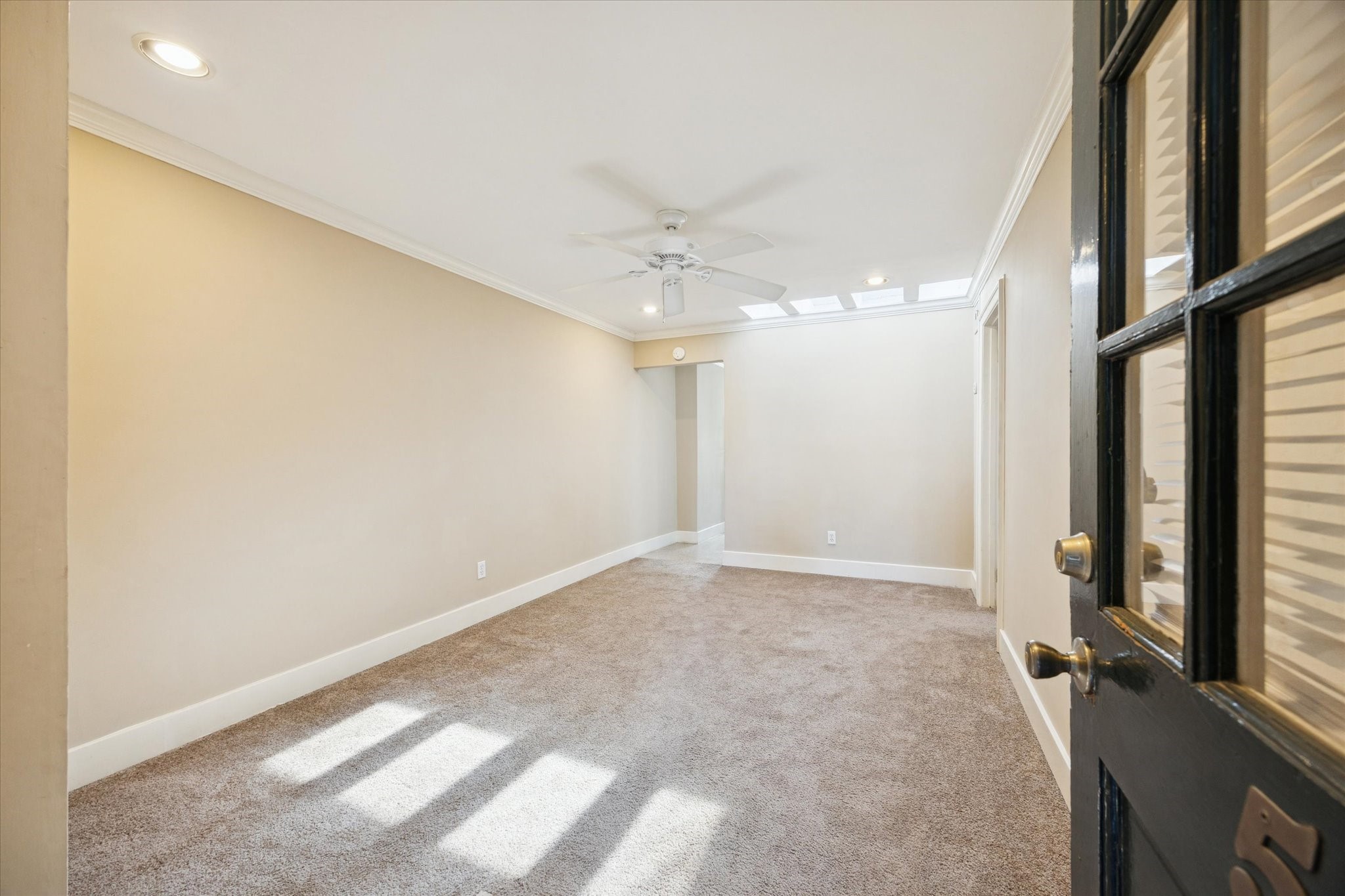 4207 Drake Street Houston, TX 77005 - Photo 5 of 24 an empty room with a chandelier fan and windows