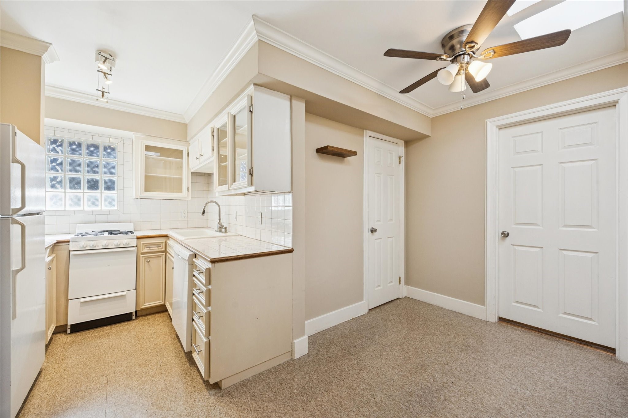 4207 Drake Street Houston, TX 77005 - Photo 9 of 24 a kitchen with white cabinets and white appliances