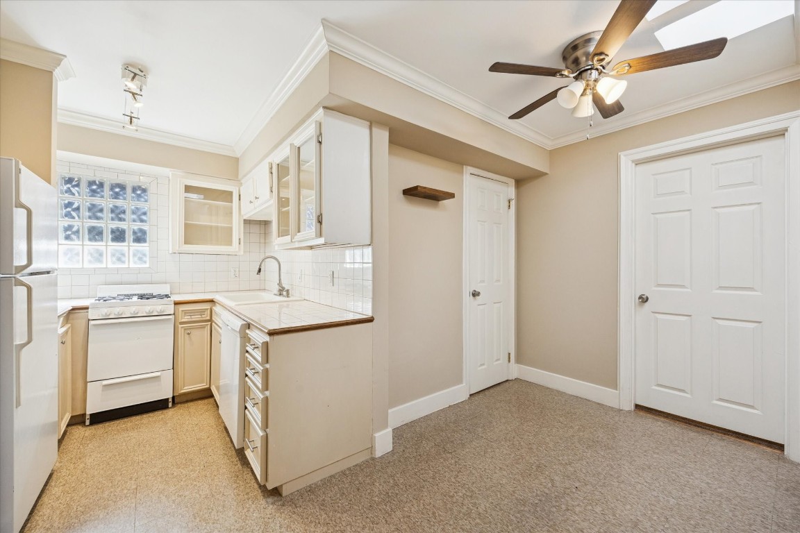 4207 Drake Street Houston, TX 77005 - Photo 9 of 24 This efficient kitchen opens to a cozy breakfast area or flex space, creating a functional flow that maximizes usable square footage. Durable finishes, ample storage, and a practical layout support everyday use while appealing to long-term rental demand.