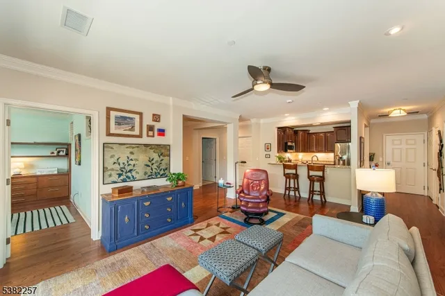 a living room with furniture and view of kitchen