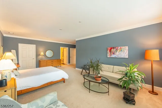 a bedroom with a bed and a potted plant