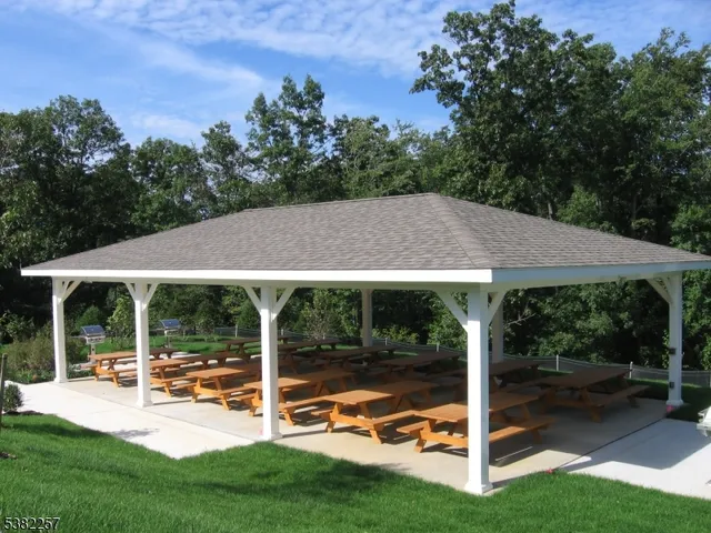 a view of a house with backyard porch and sitting area