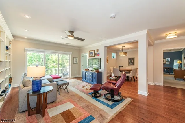 a living room with furniture gym equipment and a large window