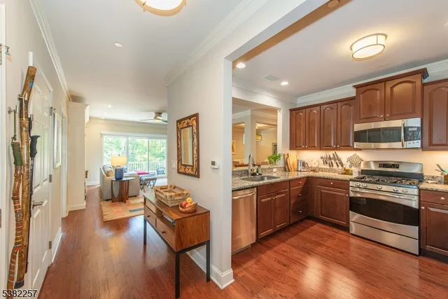 a kitchen with stainless steel appliances granite countertop a stove and a refrigerator