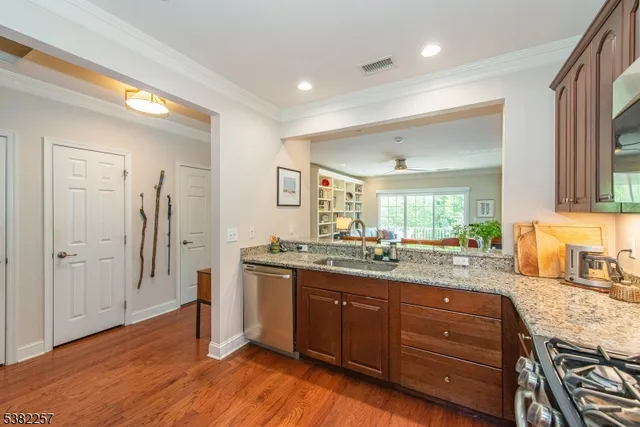 a kitchen with a sink and wooden floor