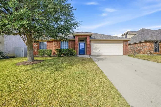 a view of a house with a yard and garage
