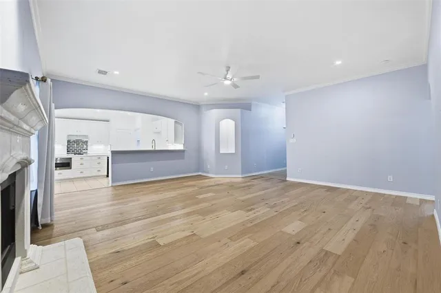 a view of an empty room with a fireplace and a window