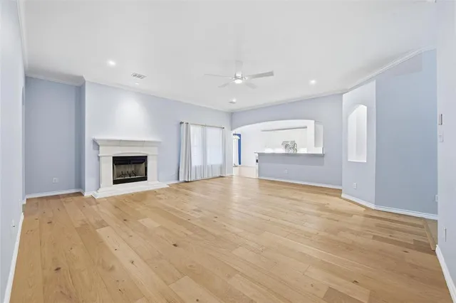 a view of an empty room with a fireplace and a window