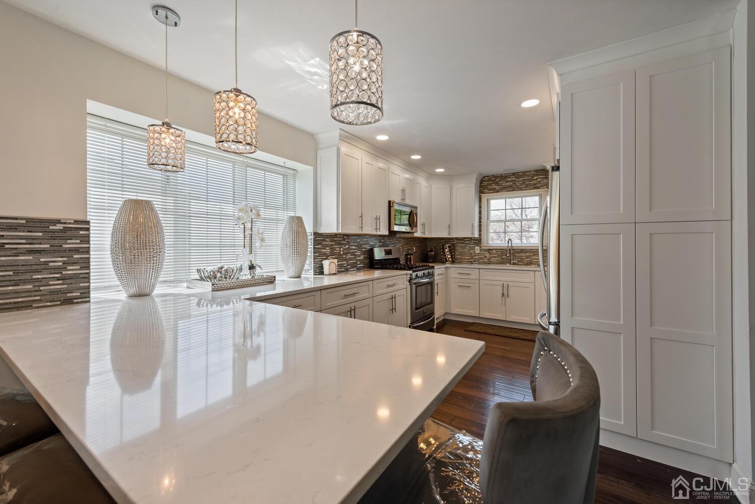 73 Appletree Road Howell, NJ 07731 - Photo 11 of 43 an open kitchen with granite countertop a sink a counter space appliances and cabinets