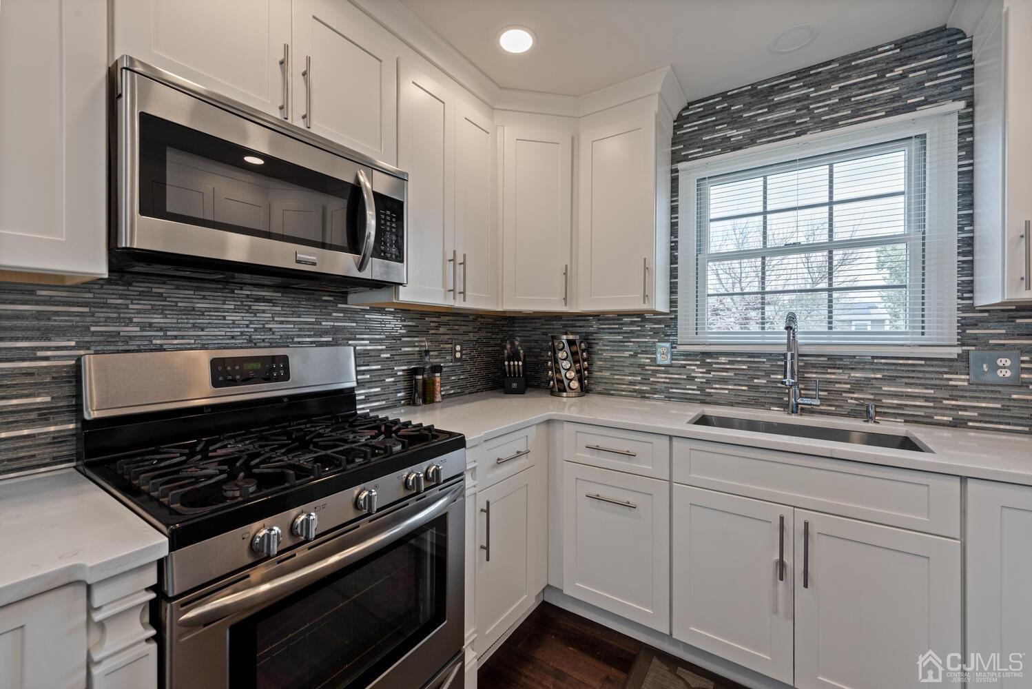 73 Appletree Road Howell, NJ 07731 - Photo 13 of 43 a kitchen with stainless steel appliances granite countertop white cabinets and a stove top oven