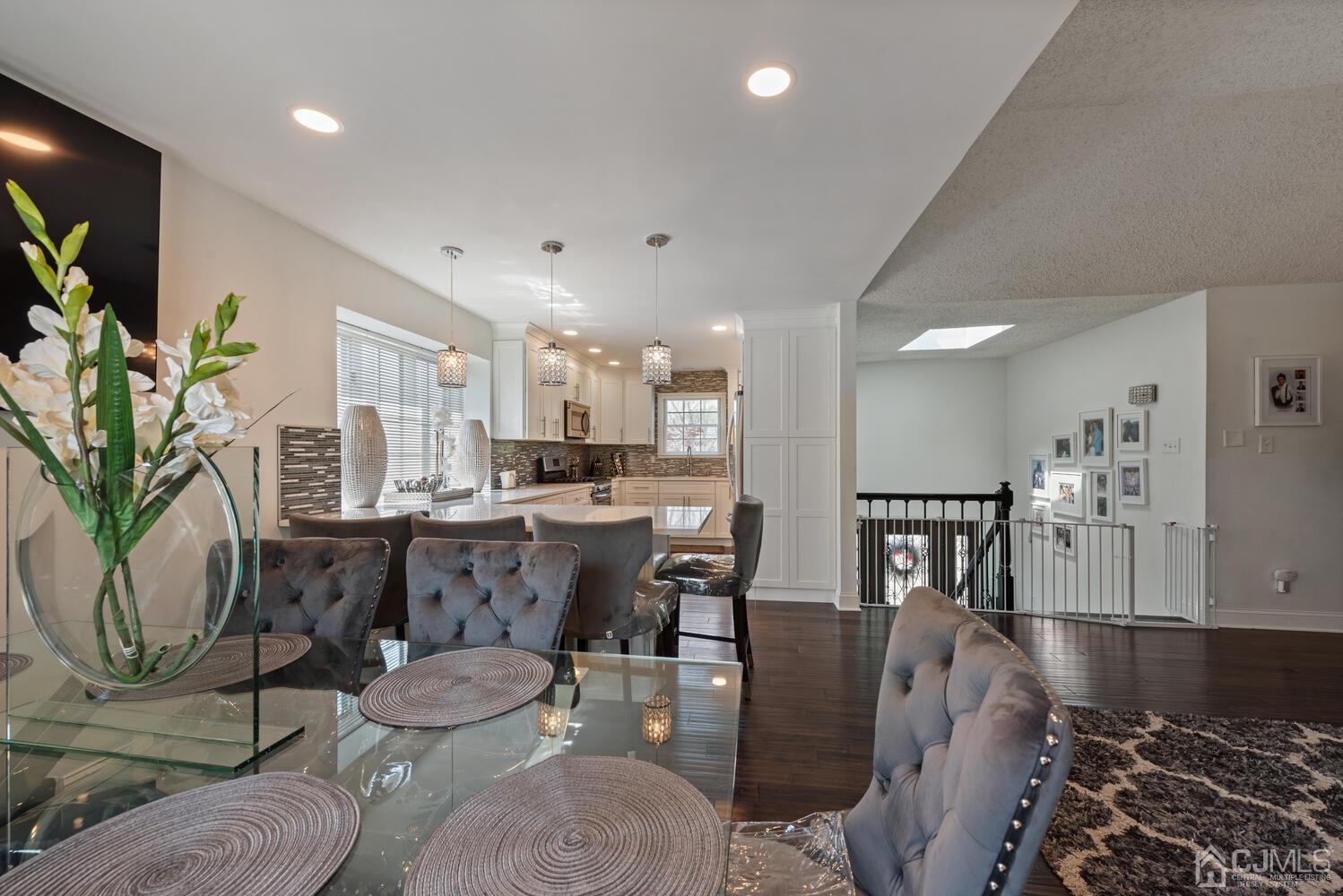 73 Appletree Road Howell, NJ 07731 - Photo 17 of 43 a living room with furniture a dining table and a potted plant
