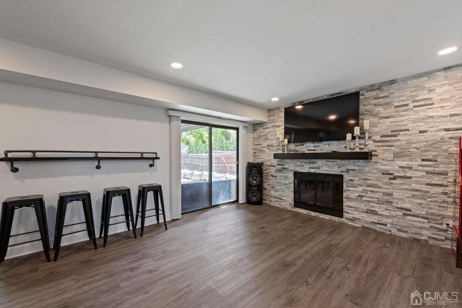 73 Appletree Road Howell, NJ 07731 - Photo 18 of 43 a living room with fireplace furniture and a flat screen tv